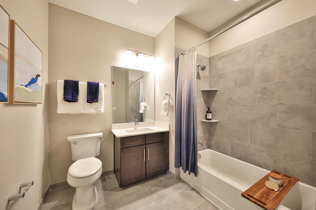 a bathroom with a toilet sink and tub and a shower