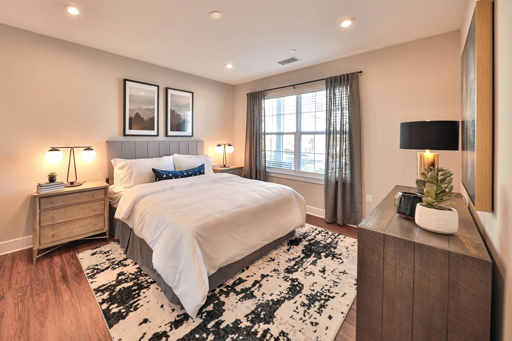 a bedroom with a bed and a dresser and a window