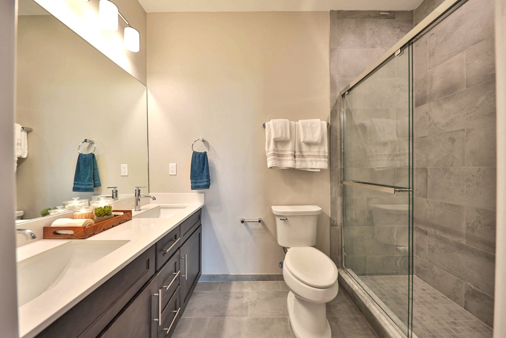 a bathroom with a toilet sink and a shower