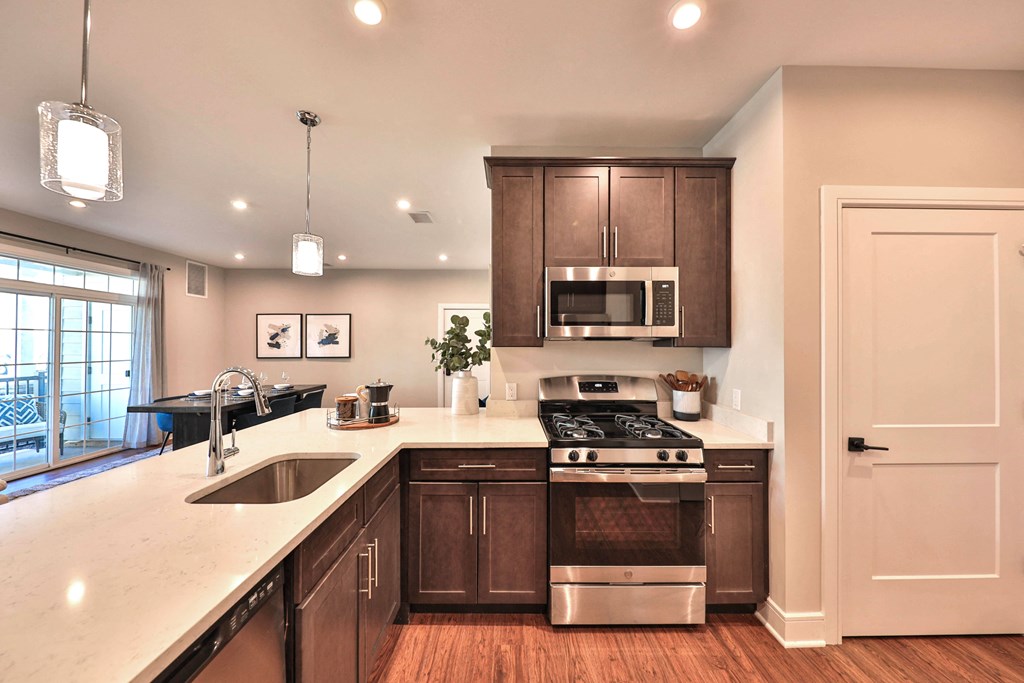 a kitchen with a sink and a stove and a microwave