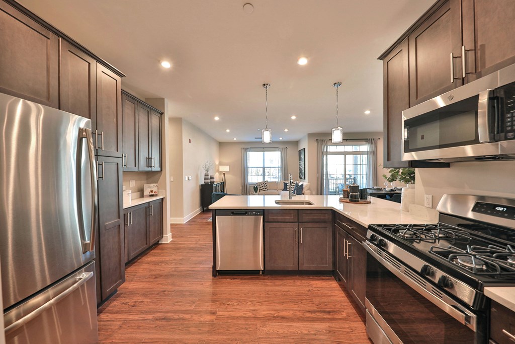 a large kitchen with stainless steel appliances and wooden cabinets