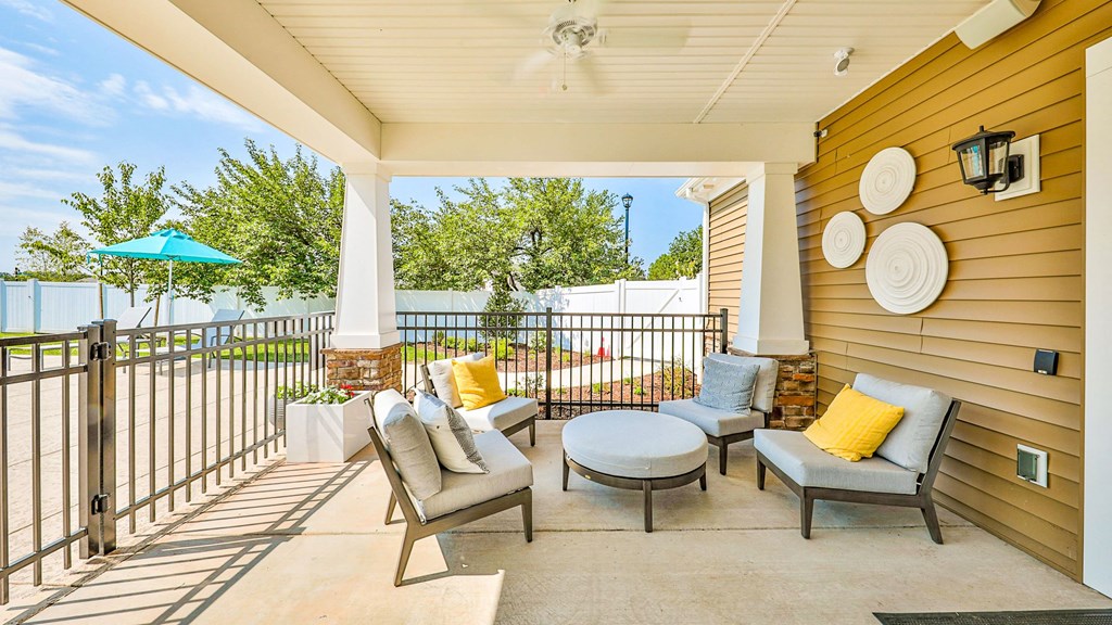 a patio with chairs and a table and a umbrella