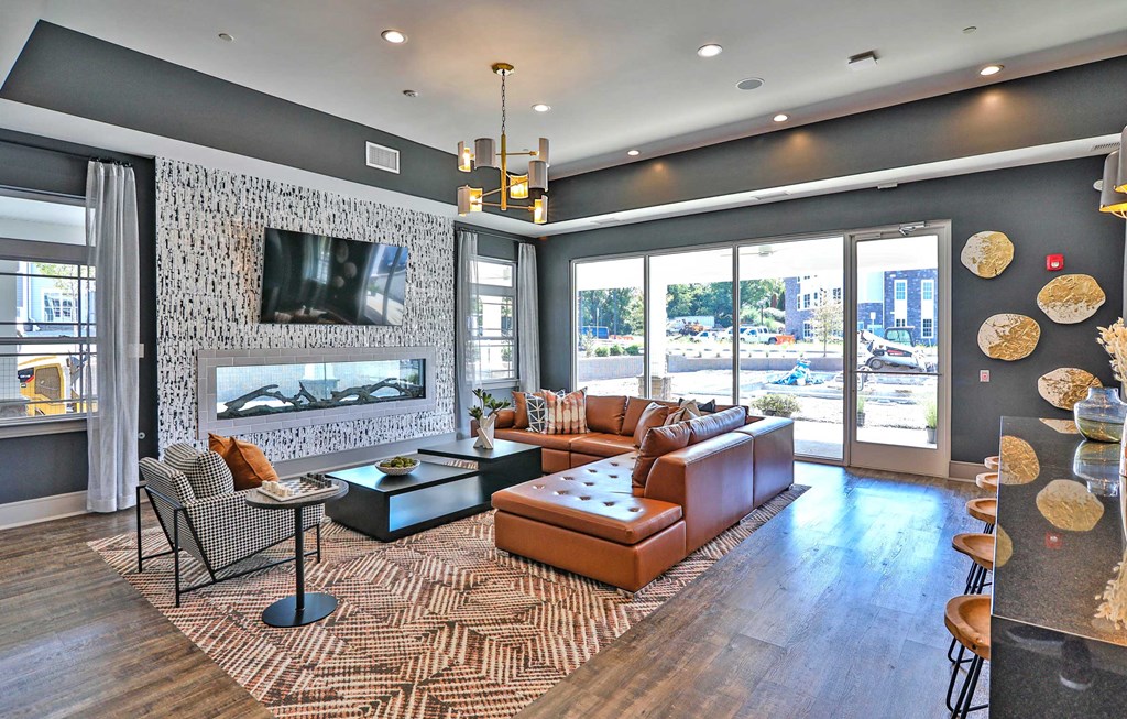 a living room with leather furniture and a fireplace