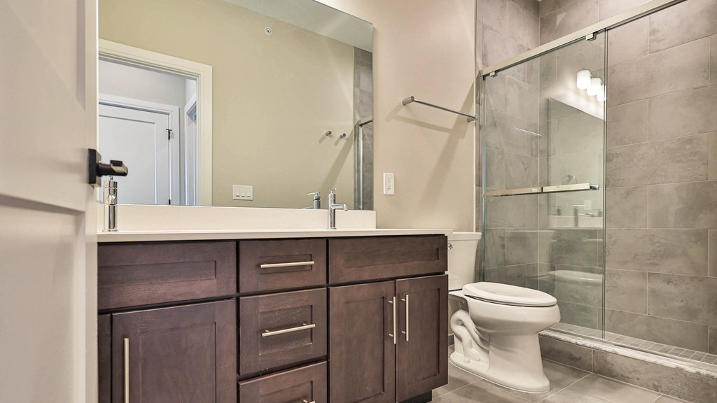 a bathroom with a toilet and a sink and a shower