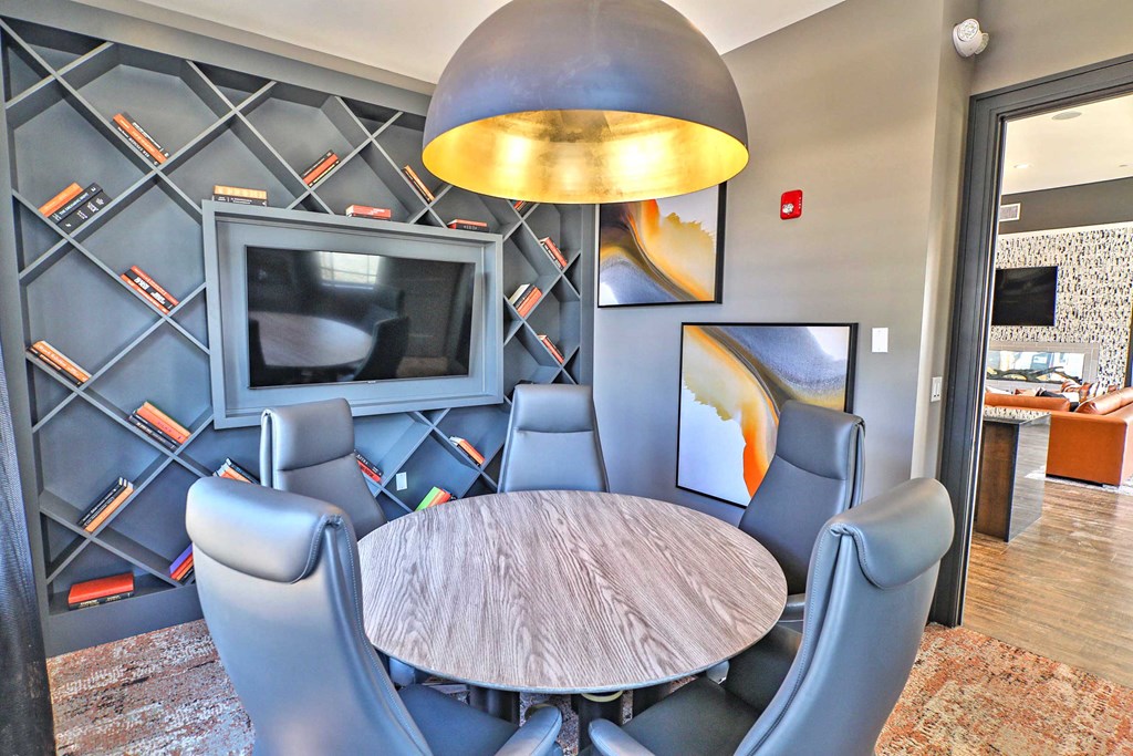 a dining room with a table and chairs and a tv