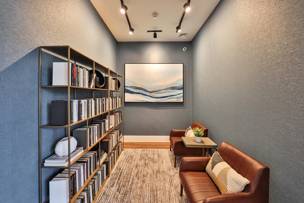 a living room with a bookshelf and couches