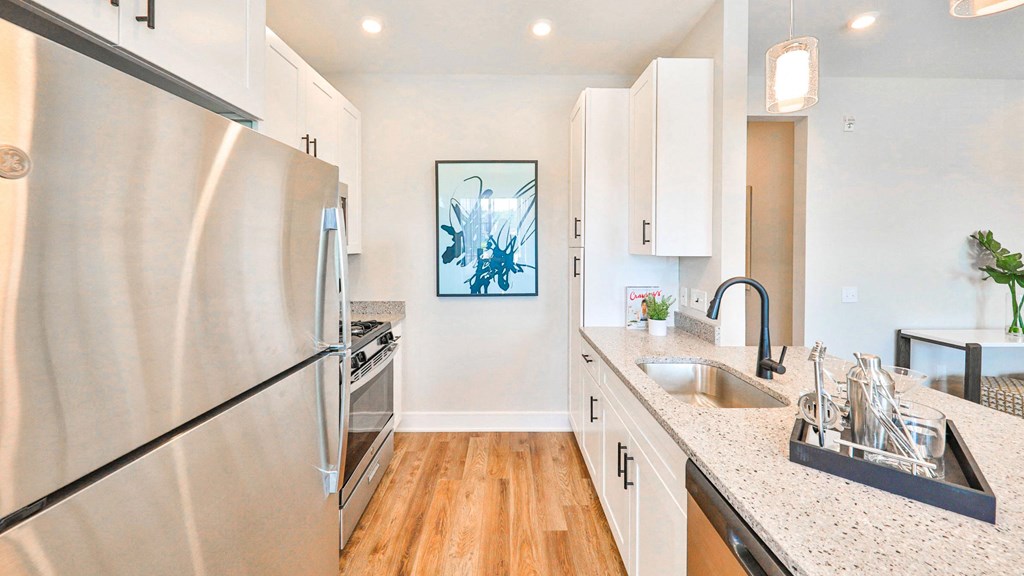 a kitchen with stainless steel appliances and white cabinets