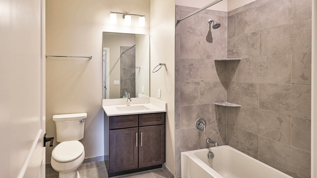 a bathroom with a sink toilet and shower and a tub