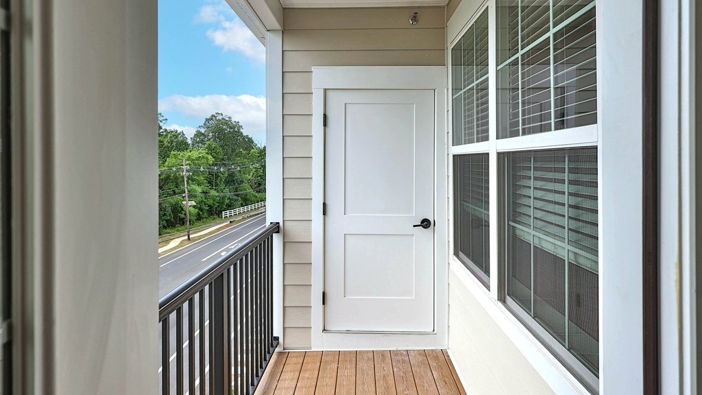 a white door on a balcony with a view of the street