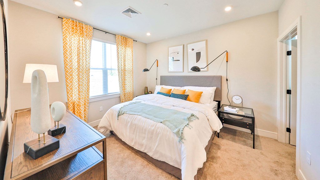 a bedroom with a bed and yellow curtains