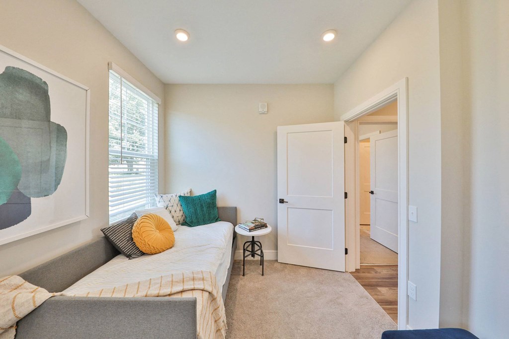 a living room with a couch and a door to a hallway