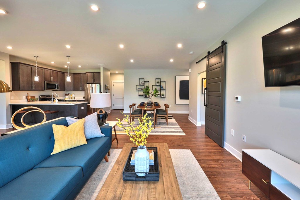 a living room with a blue couch and a table