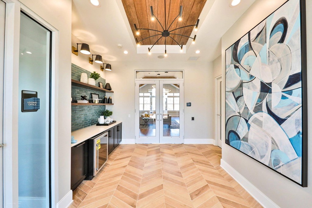 the entryway of a home with a large painting on the wall and a wood