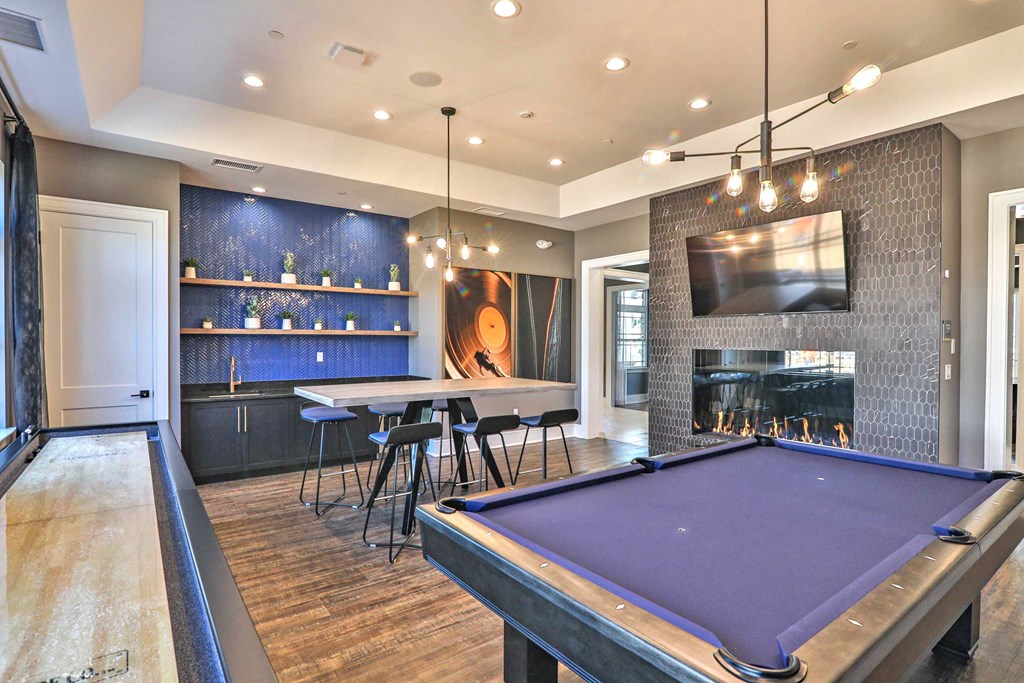 a game room with a pool table and a fireplace
