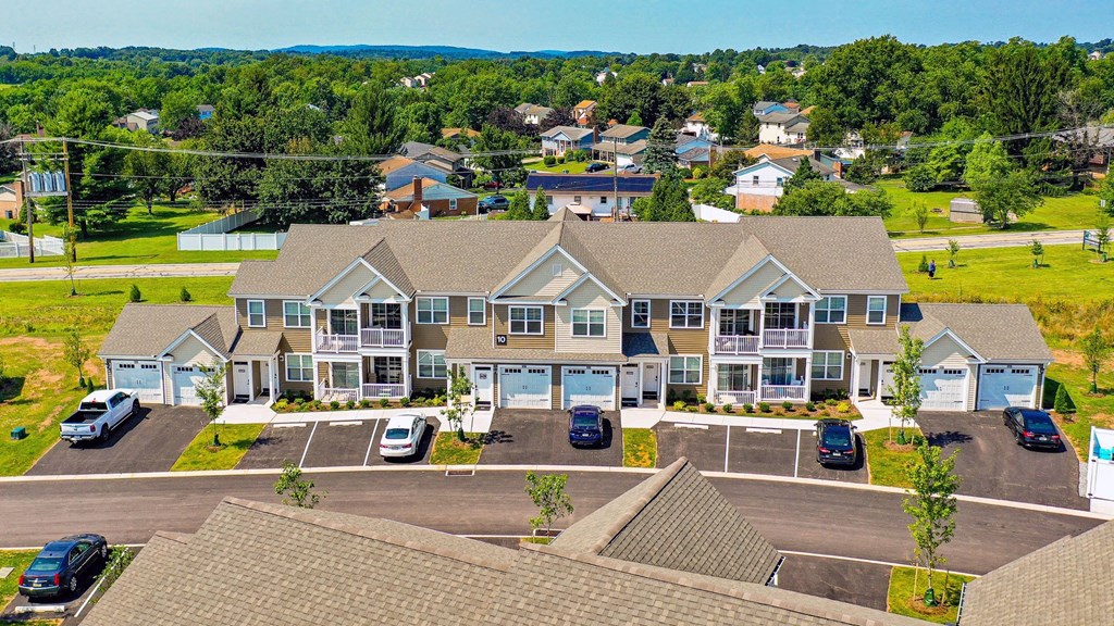 a large house with cars parked in a parking lot