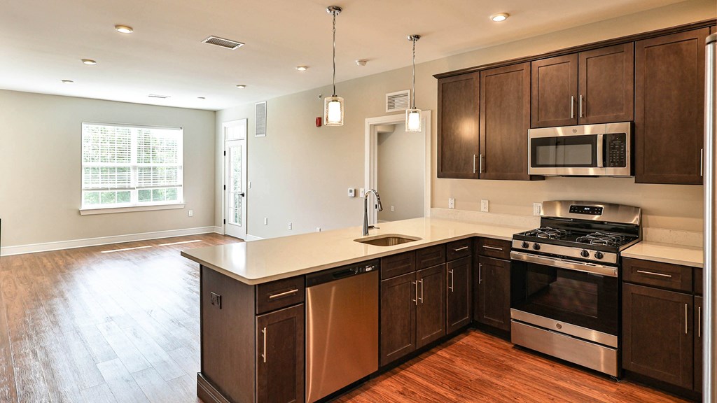a kitchen with wooden cabinets and a white counter top