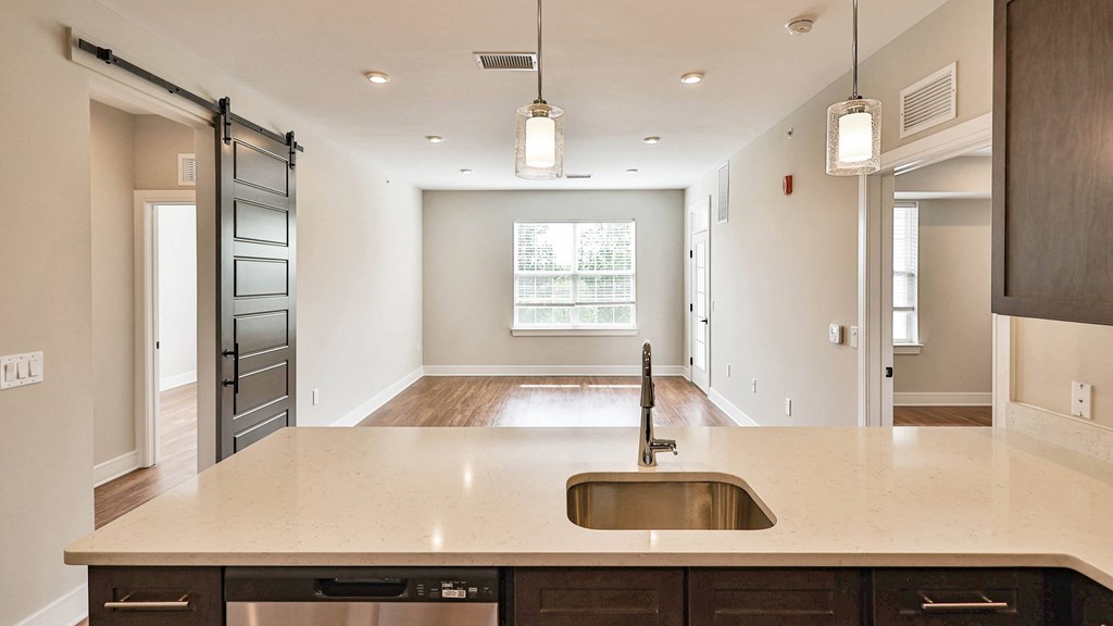 an empty kitchen with a large counter top and a sink