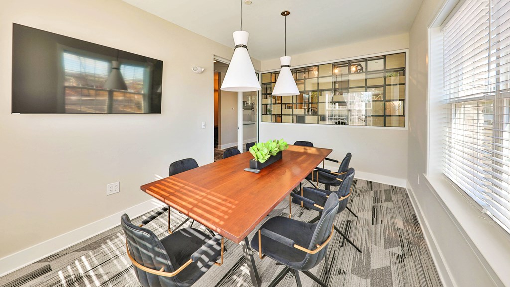 a dining room with a wooden table and chairs