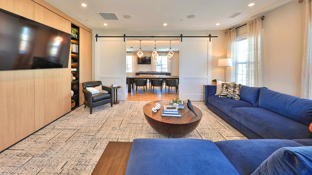 a living room with blue couches and a table