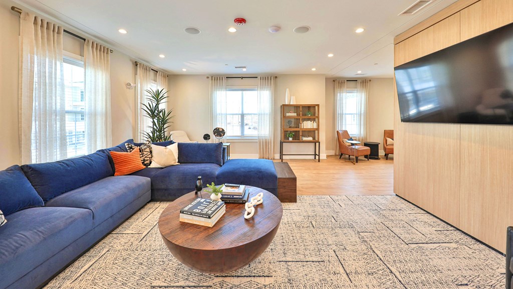 a living room with a blue couch and a coffee table