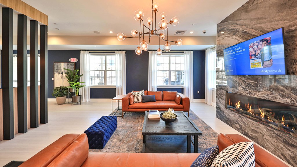 a living room with couches and a coffee table and a fireplace