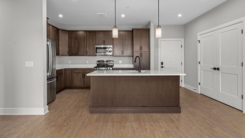 A modern kitchen with wooden cabinets and a central island.