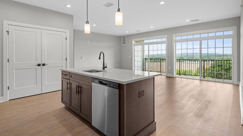 A kitchen with a large island and a view of the ocean.