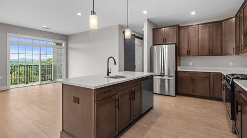 A modern kitchen with wooden cabinets and a large island.