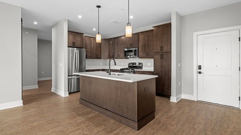 A modern kitchen with wooden cabinets and a white island.