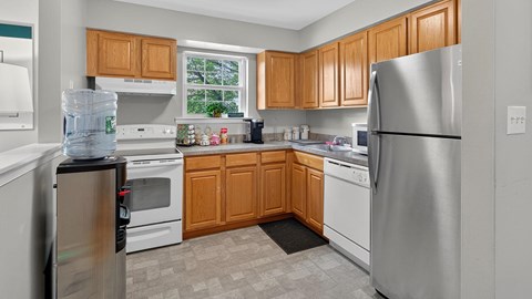 A kitchen with wooden cabinets and stainless steel appliances.