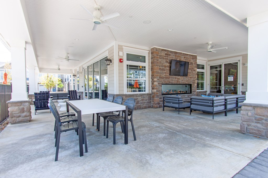 the preserve at ballantyne commons clubhouse with tables and chairs and a fireplace