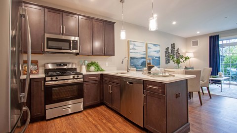 a kitchen with wooden cabinets and stainless steel appliances