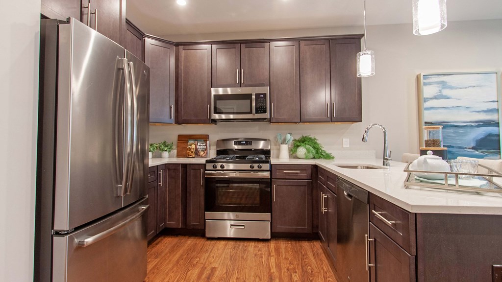 a kitchen with stainless steel appliances and wooden cabinets