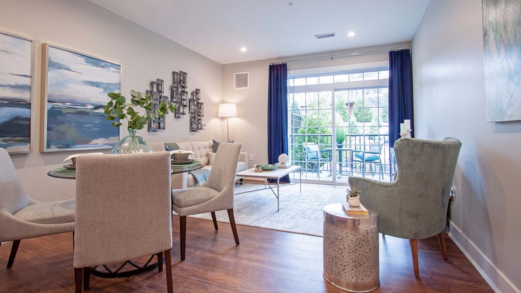 a living room and dining room with chairs and a table