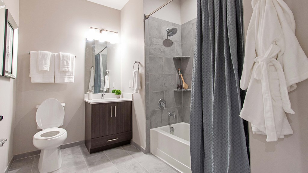 a bathroom with a shower and a toilet and a sink