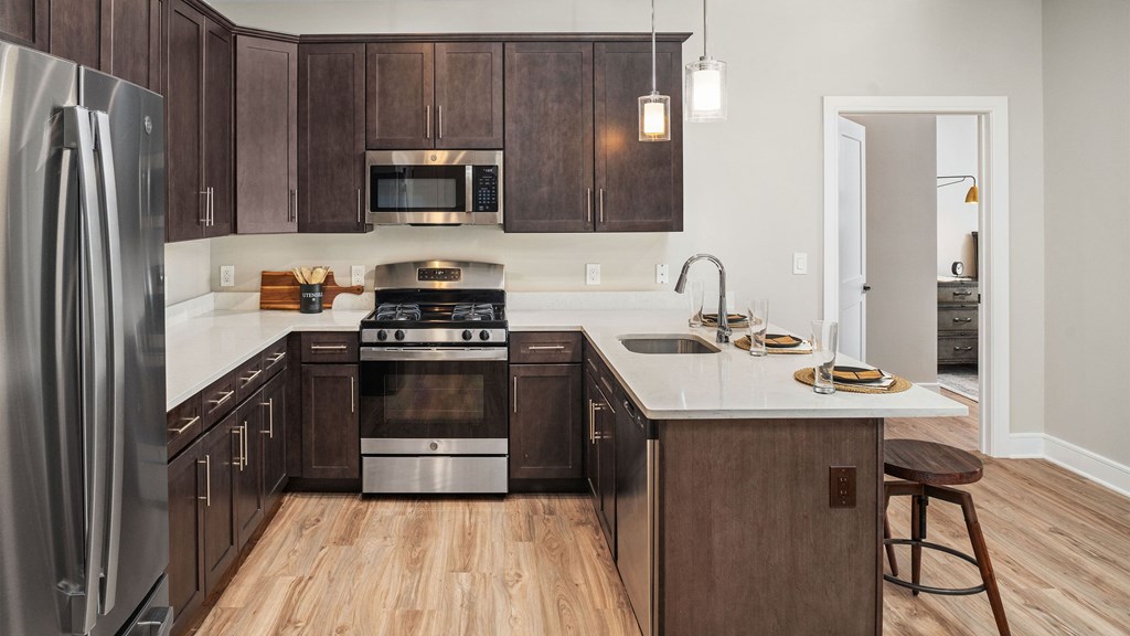 a kitchen with wooden cabinets and stainless steel appliances