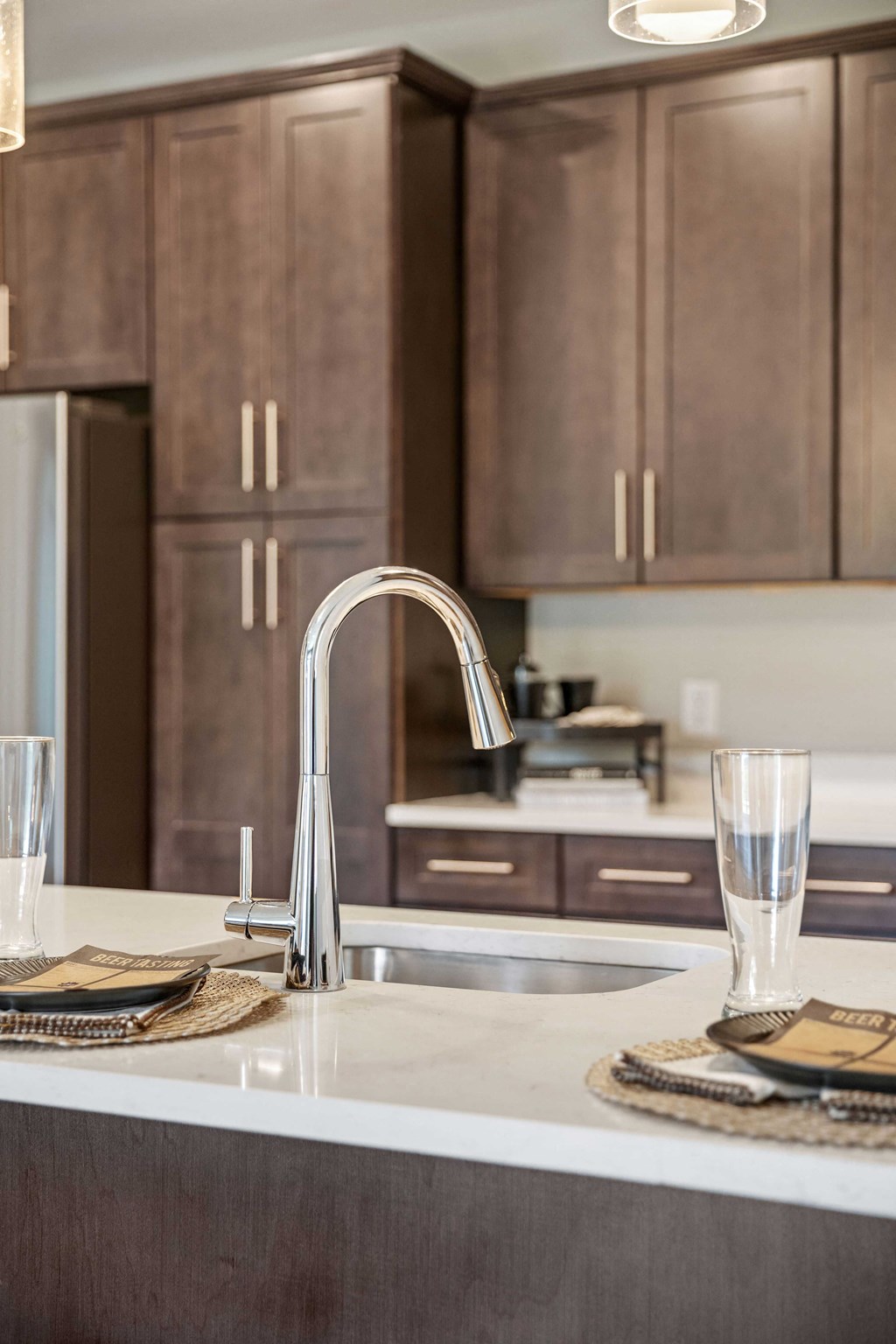 a kitchen with wooden cabinets and a sink and a faucet