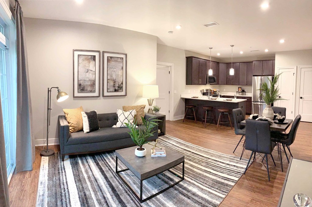 a living room and kitchen with a couch and a table