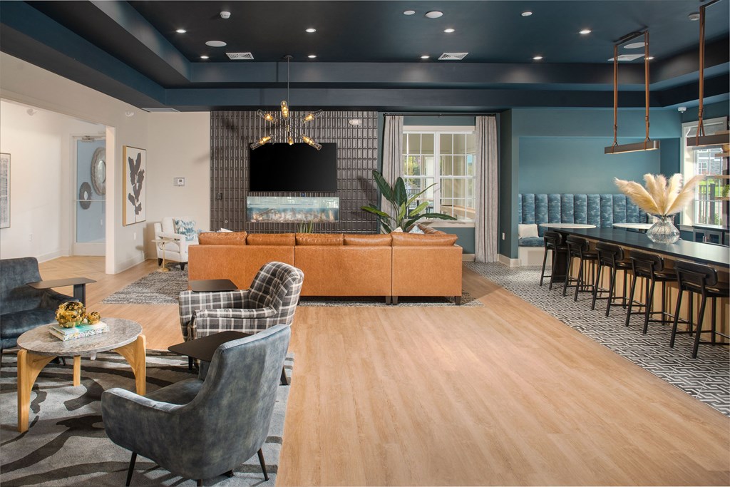 a living room with a couch and chairs and a dining room table