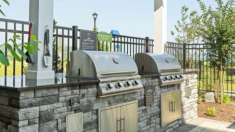 A stone wall with a metal fence and a sign that says "Parking Only".