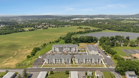 A large building with a parking lot in front of it.