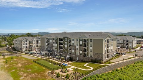 A large apartment complex with a playground in the foreground.