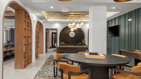 A modern dining room with a round table and chairs.