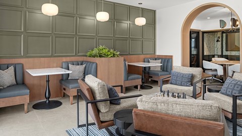 A modern cafe with grey and brown furniture.