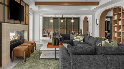 A modern living room with a fireplace and grey couches.