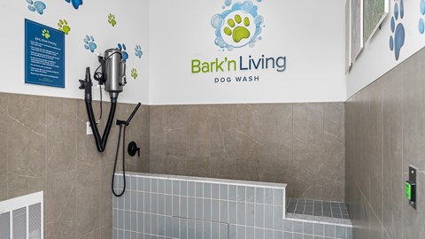 A dog wash station with a sign that says Bark'n Living.