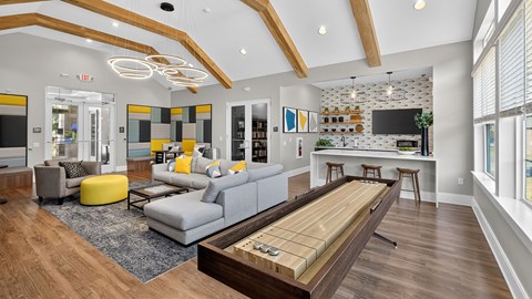 A modern living room with a grey sofa and a wooden coffee table.