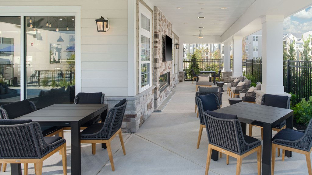 a patio with tables and chairs outside of a restaurant
