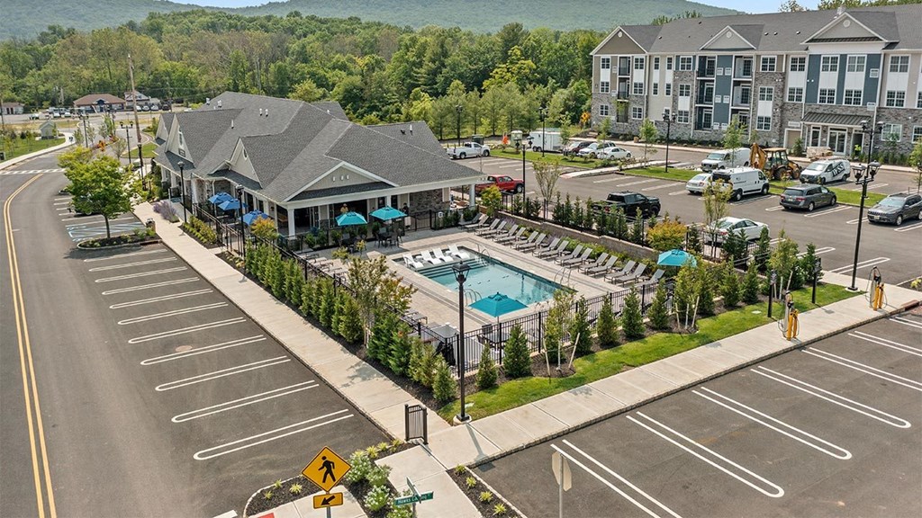 an aerial view of a swimming pool in the middle of a parking lot