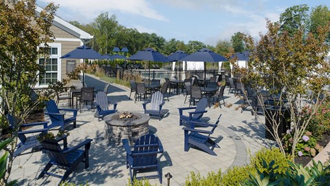 a patio with blue chairs and umbrellas and a fire pit